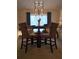 A cozy dining area featuring a round table with four chairs and modern chandelier at 6193 Charring Cross Ct, Lithonia, GA 30058