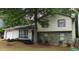 Charming two-story home with stone accents, a well-manicured lawn and mature trees at 6193 Charring Cross Ct, Lithonia, GA 30058