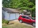 View of home showing well-maintained lawn, garage and front shrubs at 6193 Charring Cross Ct, Lithonia, GA 30058