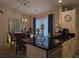 Modern kitchen with stainless steel appliances, black countertops, and a view of the dining area at 6193 Charring Cross Ct, Lithonia, GA 30058