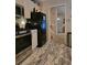 Updated kitchen features stainless steel appliances and modern flooring at 6193 Charring Cross Ct, Lithonia, GA 30058