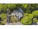 Aerial view of a stunning home with a pool, driveway and lush landscaping surrounded by mature trees at 214 Kenneth Drive, Alpharetta, GA 30009
