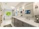 Bright bathroom featuring a double vanity, large mirror, and soaking tub at 214 Kenneth Drive, Alpharetta, GA 30009
