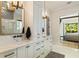 Elegant bathroom features a double vanity with marble countertop, modern fixtures, and a glimpse into the bedroom at 214 Kenneth Drive, Alpharetta, GA 30009
