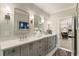 A bright, dual vanity bathroom with white countertop and grey cabinets at 214 Kenneth Drive, Alpharetta, GA 30009