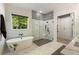 Elegant bathroom with a freestanding tub, glass shower, and stylish tile work at 214 Kenneth Drive, Alpharetta, GA 30009