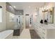 Stylish bathroom with a modern tub, glass shower, herringbone tile, and decorative black and white accent wall at 214 Kenneth Drive, Alpharetta, GA 30009