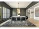 This dining room offers black trim, light hardwood floors, and a decorative lighting fixture above the table at 214 Kenneth Drive, Alpharetta, GA 30009