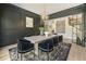 A modern dining room featuring a chandelier, a grey rug, and a table with six black chairs at 214 Kenneth Drive, Alpharetta, GA 30009
