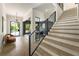 Bright foyer featuring hardwood floors, a staircase with iron railing, and a view into the office at 214 Kenneth Drive, Alpharetta, GA 30009