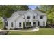 Stunning two-story home with a white board and batten exterior and manicured front yard at 214 Kenneth Drive, Alpharetta, GA 30009