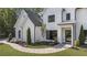 Charming two-story home with a white board and batten exterior and landscaped front yard at 214 Kenneth Drive, Alpharetta, GA 30009