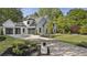Elegant two-story home showcasing a manicured front yard, driveway, and attached garage offering curb appeal at 214 Kenneth Drive, Alpharetta, GA 30009