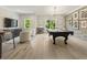 Bright game room featuring a pool table, entertainment center, and natural light at 214 Kenneth Drive, Alpharetta, GA 30009