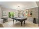 Well lit game room featuring a dark wood pool table and accent brick wall at 214 Kenneth Drive, Alpharetta, GA 30009