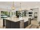 Modern kitchen featuring a center island with seating, pendant lighting, and stainless steel appliances at 214 Kenneth Drive, Alpharetta, GA 30009