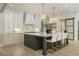 Spacious kitchen with white cabinetry, modern island, stylish light fixtures, and stainless steel appliances at 214 Kenneth Drive, Alpharetta, GA 30009