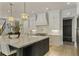 Modern kitchen with a large island, stainless steel appliances, pendant lighting, and ample cabinet space at 214 Kenneth Drive, Alpharetta, GA 30009