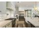Stylish kitchen with a gas range, stainless steel appliances, and a view of the living room at 214 Kenneth Drive, Alpharetta, GA 30009