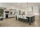 Open kitchen with a large island, stainless steel appliances, pendant lighting, and a view of the living room at 214 Kenneth Drive, Alpharetta, GA 30009
