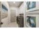 Well-lit laundry room featuring modern washer, dryer, and unique floor tiles at 214 Kenneth Drive, Alpharetta, GA 30009