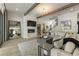 Cozy living room with a fireplace, a comfortable sofa, a decorative mirror, and stairs leading upstairs at 214 Kenneth Drive, Alpharetta, GA 30009