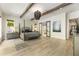 Spacious main bedroom featuring wood beams, an ensuite bathroom, and natural light at 214 Kenneth Drive, Alpharetta, GA 30009