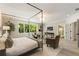 Main bedroom with a four poster bed, sitting area, and large bright windows at 214 Kenneth Drive, Alpharetta, GA 30009