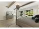 Bright main bedroom featuring wood beams, four-post bed, elegant decor, and a picturesque window view at 214 Kenneth Drive, Alpharetta, GA 30009