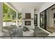 Cozy covered patio with brick fireplace, stone floor, and comfortable seating at 214 Kenneth Drive, Alpharetta, GA 30009