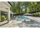 Backyard pool area with lounge chairs and a spa, perfect for relaxation at 214 Kenneth Drive, Alpharetta, GA 30009