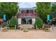 Chic restaurant exterior with a trellis covered in flowers, surrounded by manicured landscaping at 214 Kenneth Drive, Alpharetta, GA 30009
