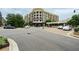 Street view in Avalon with multi-story buildings and various parked cars at 214 Kenneth Drive, Alpharetta, GA 30009