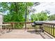 Back deck with grill and small table overlooking backyard at 2253 Carrington Dr, Ellenwood, GA 30294
