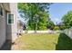 Expansive backyard with lush green grass, surrounded by a white fence and mature trees, creating a private oasis at 2253 Carrington Dr, Ellenwood, GA 30294