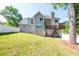 Two story home featuring a large backyard with a deck, white fence, and mature trees at 2253 Carrington Dr, Ellenwood, GA 30294