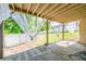View of the backyard from the covered patio, featuring white curtains and a white fence at 2253 Carrington Dr, Ellenwood, GA 30294