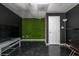 Basement features modern design, a bold accent wall, comfortable seating, and entertainment setup for leisure and relaxation at 2253 Carrington Dr, Ellenwood, GA 30294