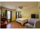 Bright bedroom with chair, bed, television, hardwood floors, and natural light at 2253 Carrington Dr, Ellenwood, GA 30294