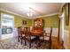 Bright dining room with hardwood floors, a large table with seating for six, and a decorative china cabinet at 2253 Carrington Dr, Ellenwood, GA 30294