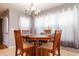 Cozy dining area with wood table, four chairs, chandelier lighting and natural light from windows at 2253 Carrington Dr, Ellenwood, GA 30294
