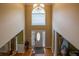 High ceiling foyer showcasing the front door, chandelier, tile flooring and staircase at 2253 Carrington Dr, Ellenwood, GA 30294