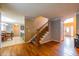 Hallway showcasing hardwood floors, stairs and a view into a dining room and kitchen at 2253 Carrington Dr, Ellenwood, GA 30294