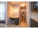 Hallway with adjacent built in desk and drawers, tile flooring, and access to a laundry room at 2253 Carrington Dr, Ellenwood, GA 30294