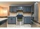 Kitchen featuring stainless steel appliances, ample cabinet space, and tiled floors at 2253 Carrington Dr, Ellenwood, GA 30294