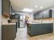 Well-lit kitchen featuring stainless steel appliances, granite countertops, and tiled floors at 2253 Carrington Dr, Ellenwood, GA 30294