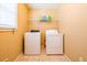 Functional laundry room featuring a washer, dryer, shelving and tile floors at 2253 Carrington Dr, Ellenwood, GA 30294