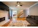 Open concept living room with brick fireplace, hardwood floors and a staircase leading upstairs at 2253 Carrington Dr, Ellenwood, GA 30294