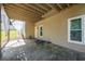 Covered patio beneath a wood-beamed deck, with a white curtain and access to the backyard at 2253 Carrington Dr, Ellenwood, GA 30294