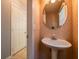Powder room with pedestal sink, ornate patterned wall paper, and tile flooring at 2253 Carrington Dr, Ellenwood, GA 30294